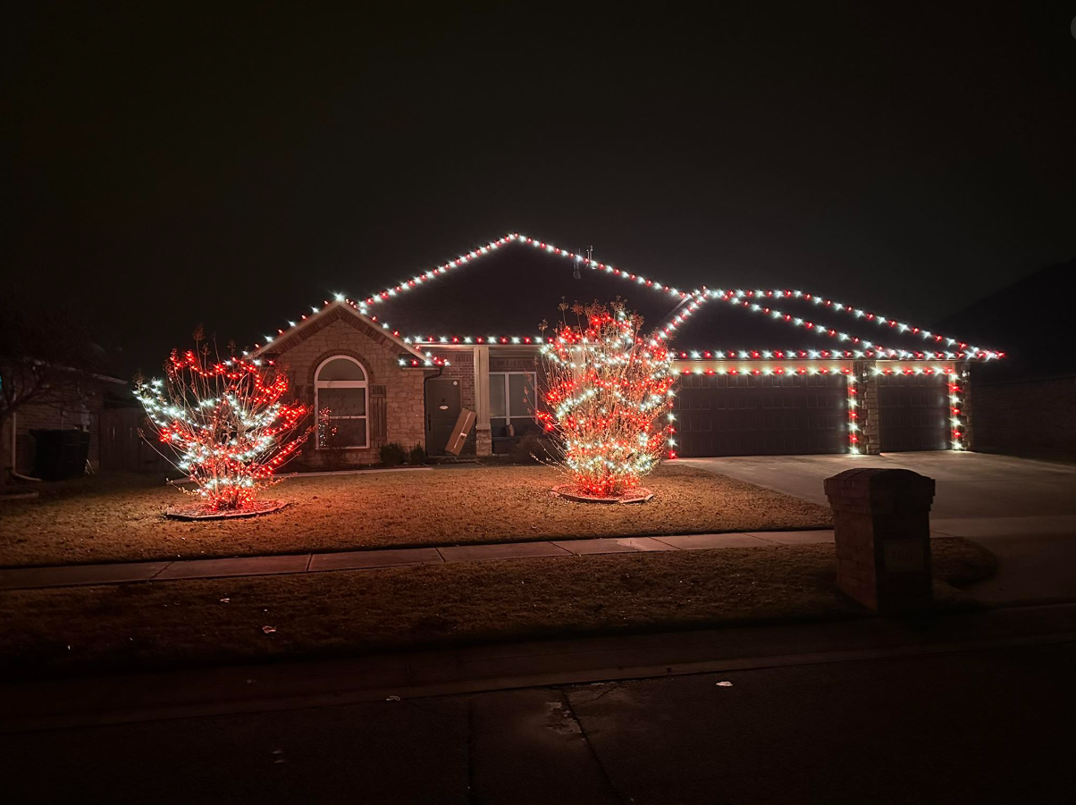 Christmas lights on house roofline and trees